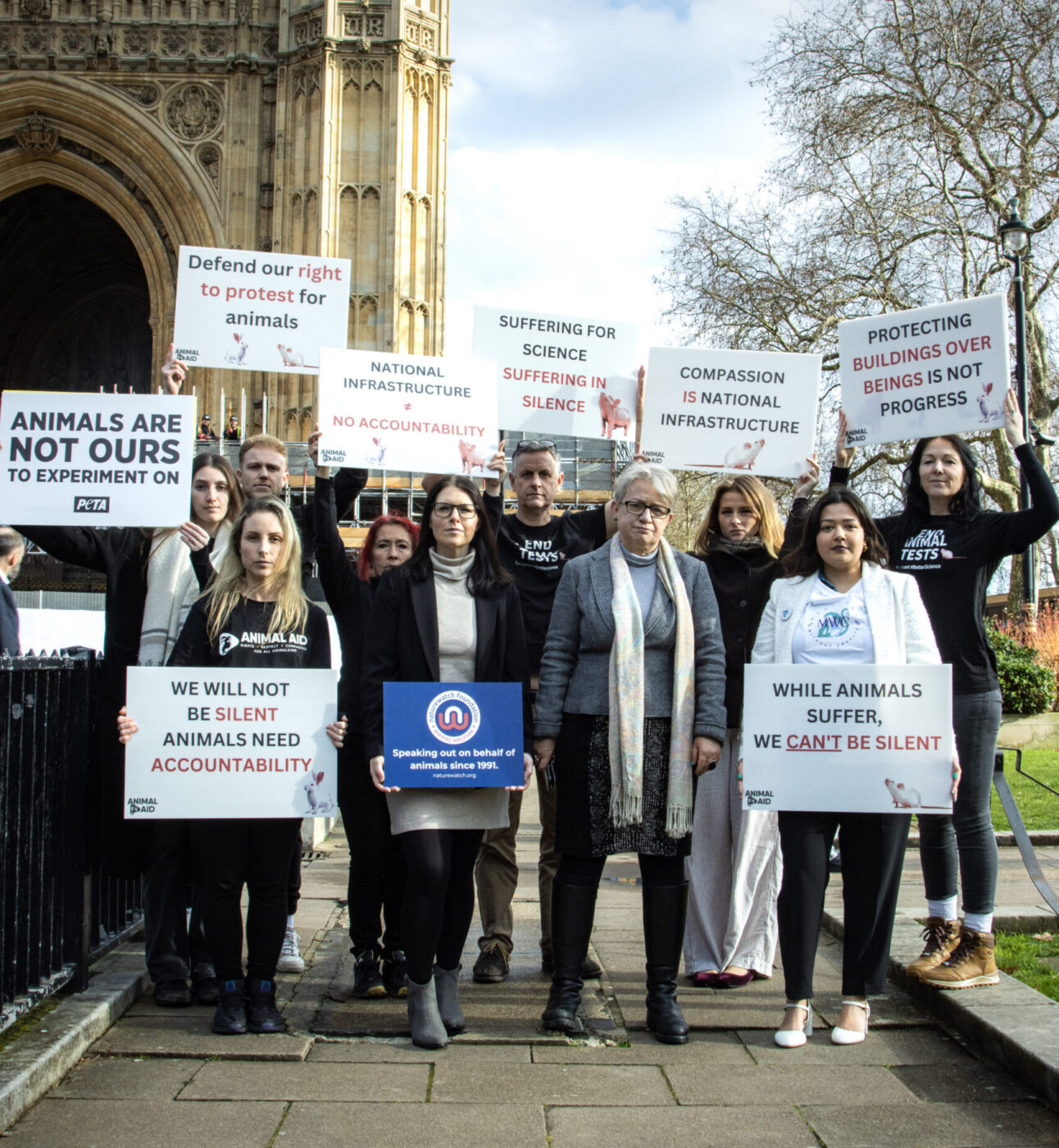 Protesters standing together outside of the Houses of Parliament.